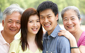 Elderly couple smiling with younger couple